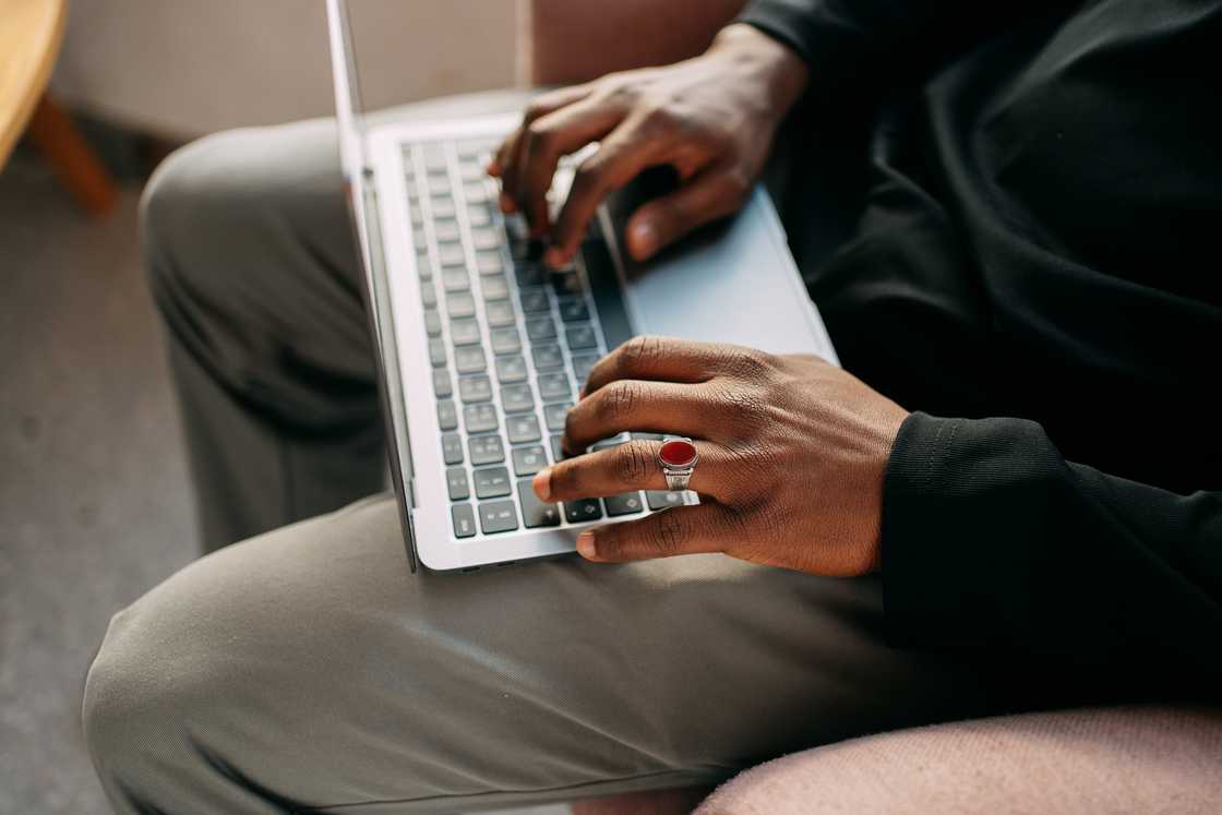 A man using a laptop to apply for a clearance certificate