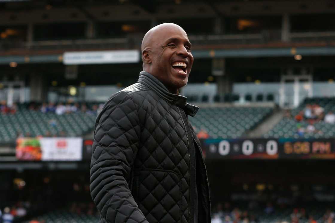 Former San Francisco Giants player Barry Bonds looks on in a black jacket