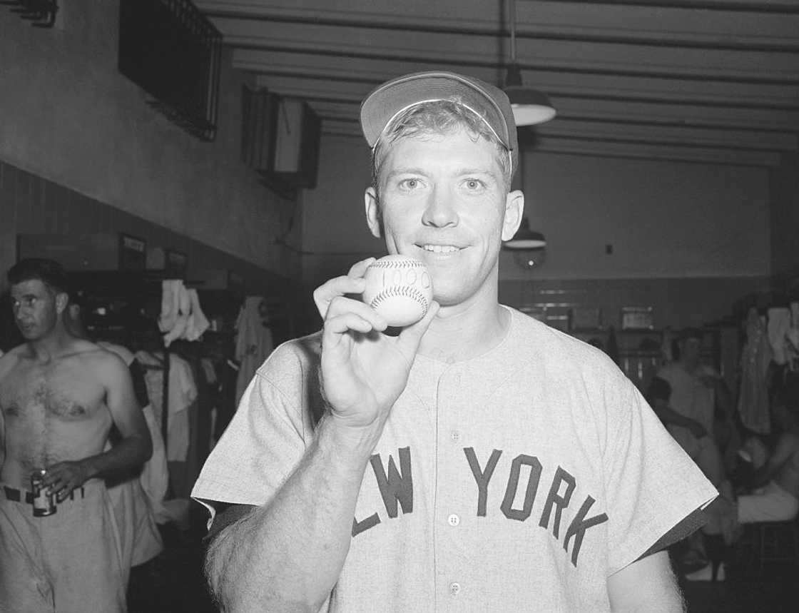 Mickey Mantle holds a baseball