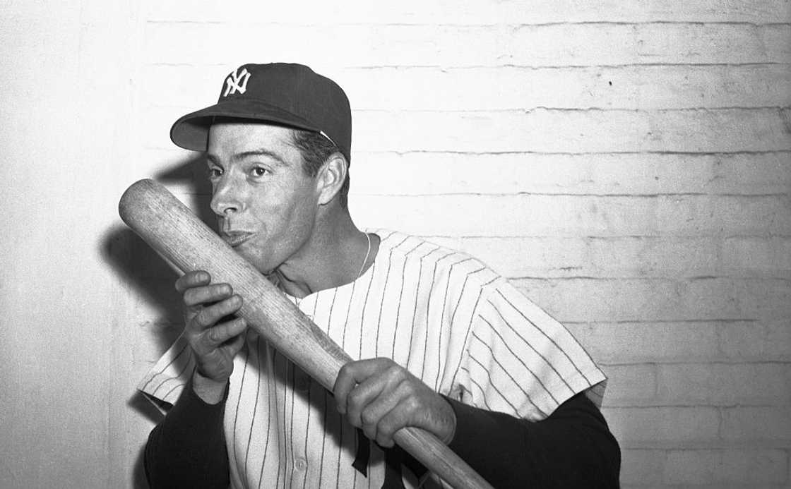 Joe DiMaggio poses with a bat