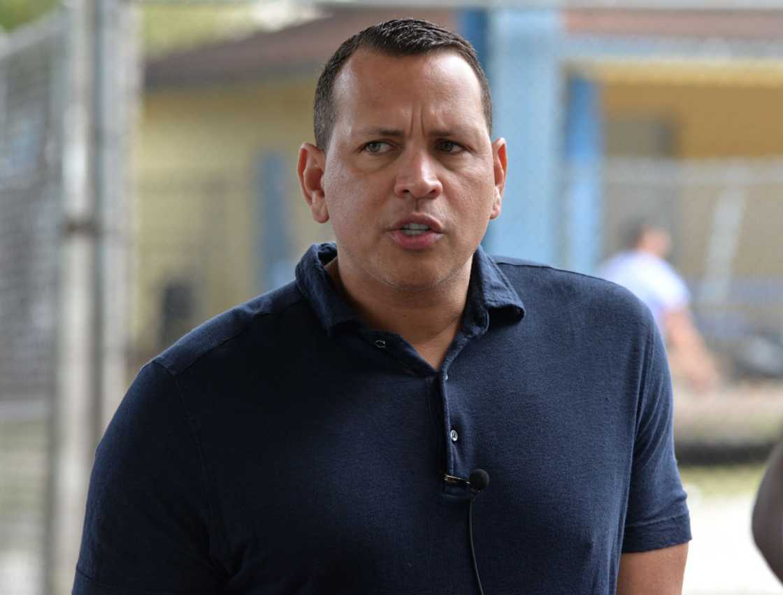 Alex Rodriguez looks on in a navy blue T-shirt