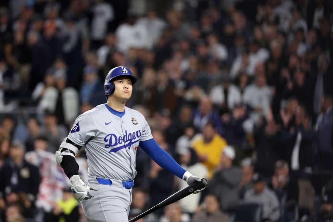 Shohei Ohtani in the Los Angeles Dodgers jersey holding a bat