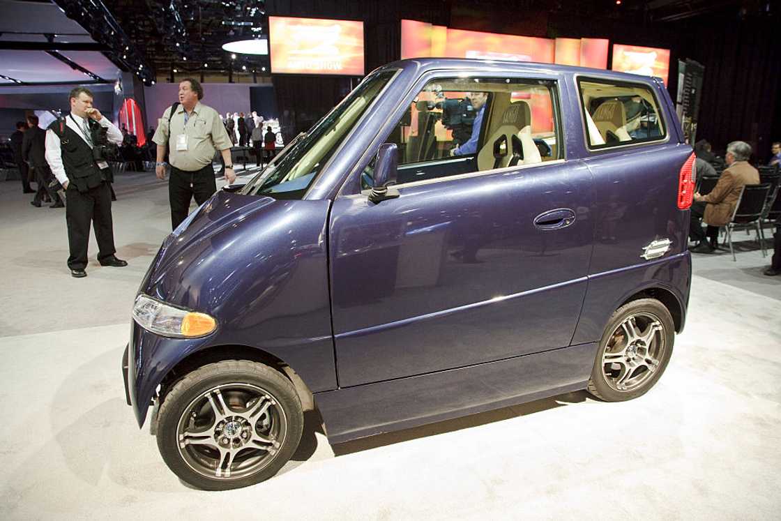 A navy blue Commuter Cars' Tango electric car on display