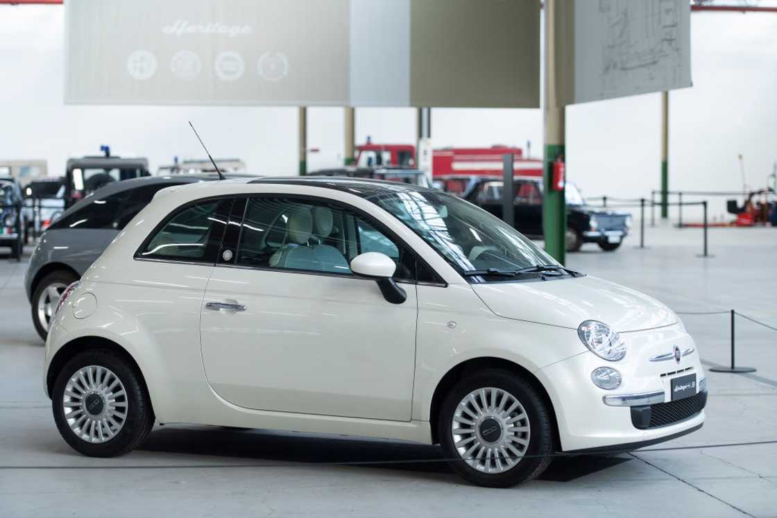 A white Fiat 500 car parked