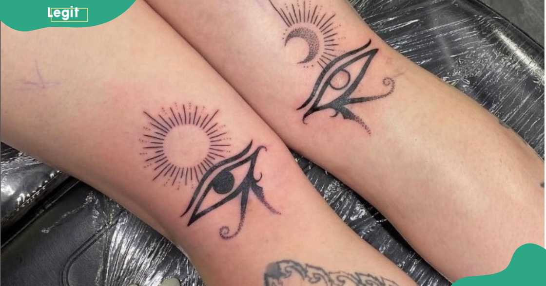 Eye of Horus tattoos on the back of the legs.