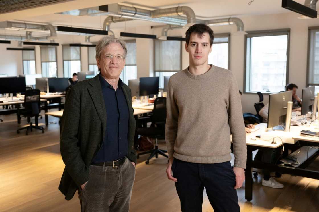 French CEO of Agence France Presse Fabrice Fries stands with French founder of artificial intelligence start-up Mistral AI, Arthur Mensch at the Mistral headquarters in Paris