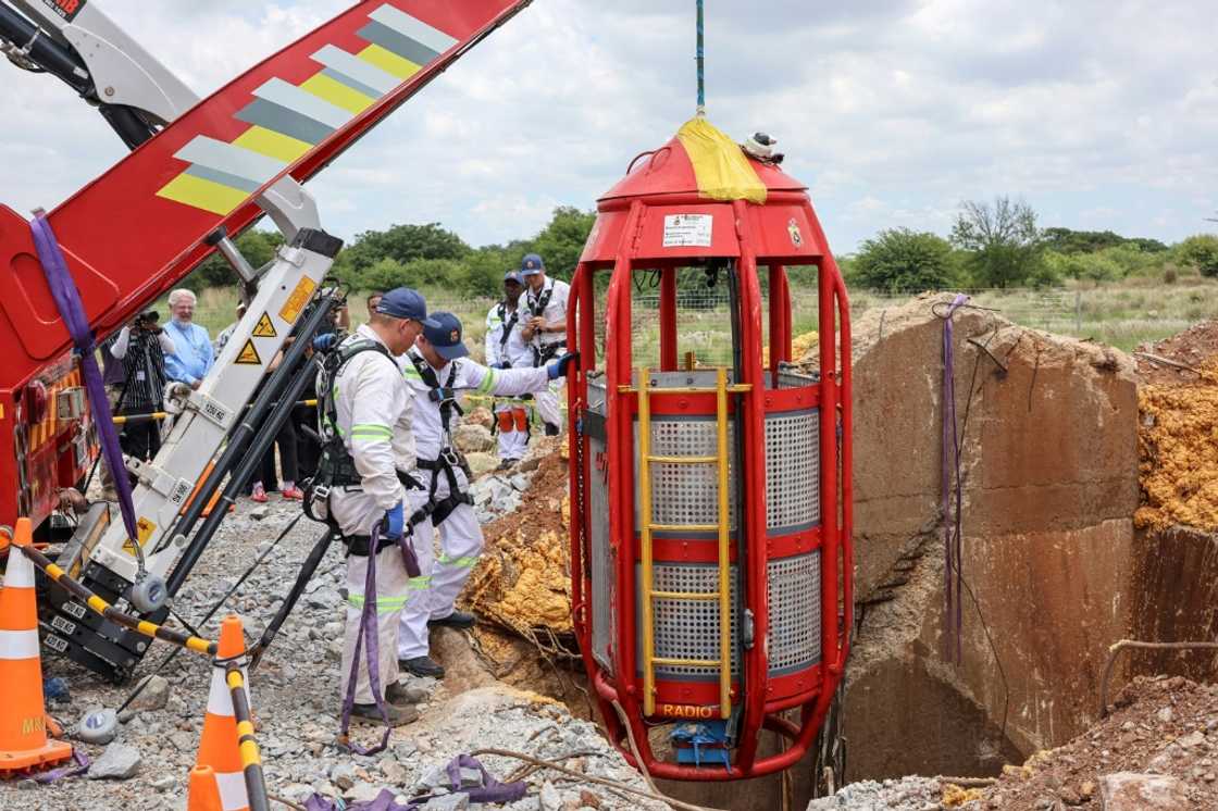 Rescuers sent down a specialised machine with a cage to lift the miners out