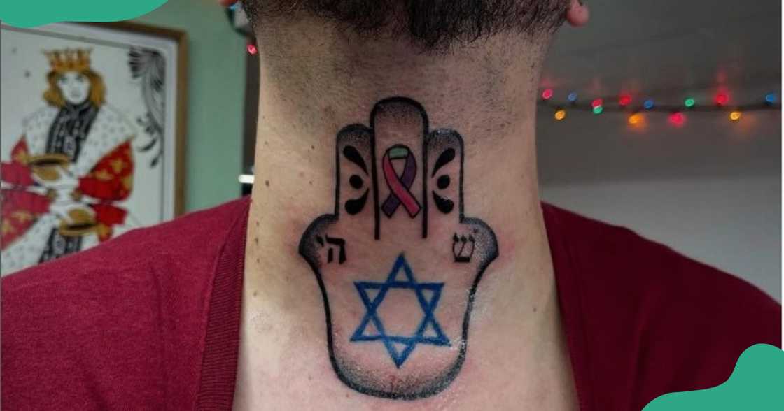 A Hand of Hamsa tattoo on the throat.