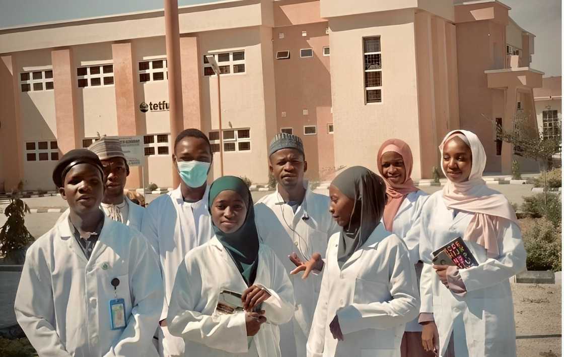 A group of students wearing white lab coats