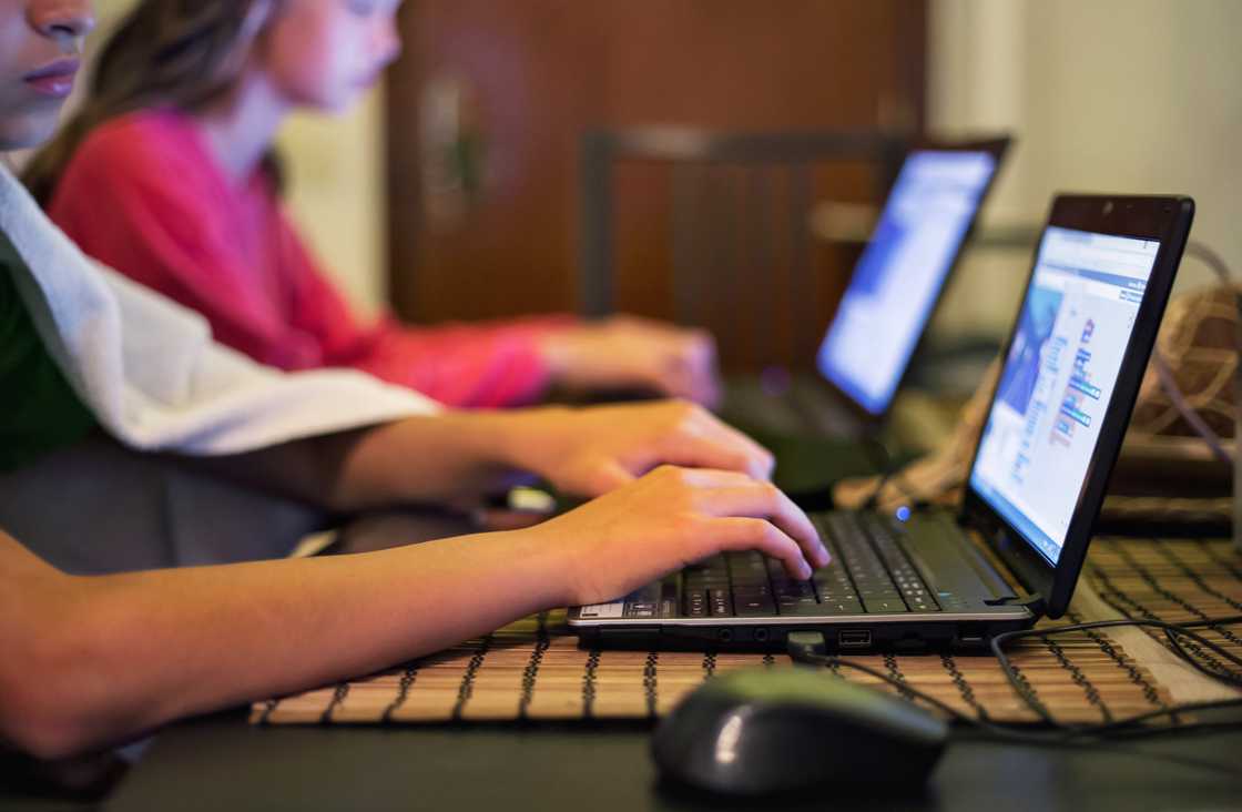 Kids typing on laptops