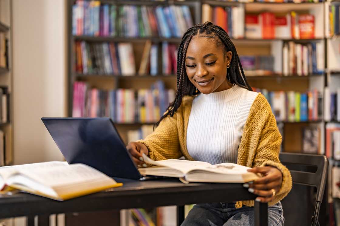 A female university student using a laptop while studying.