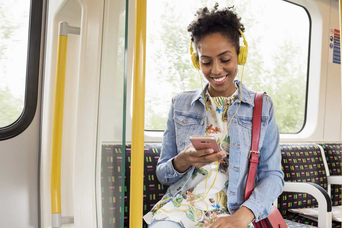 A woman using a phone on a train