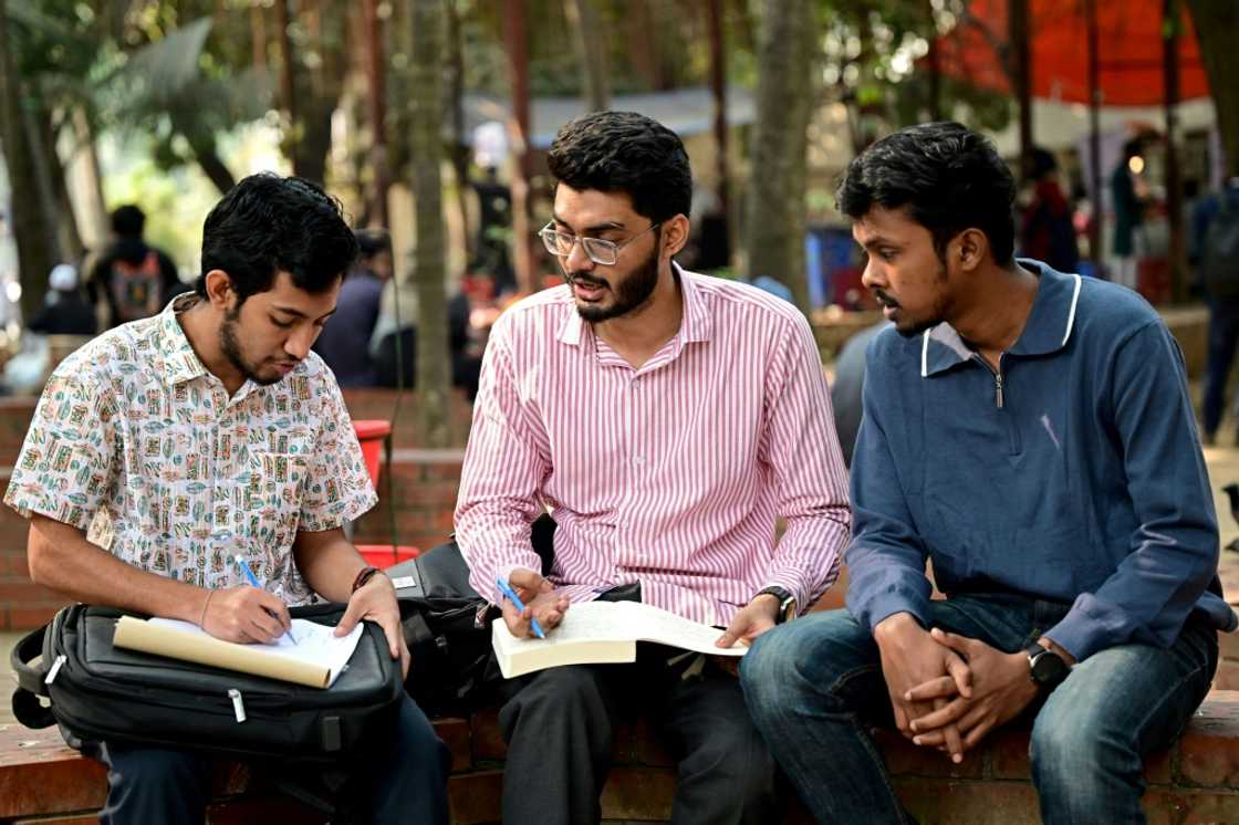 Dhaka University student Mohammad Rizwan Chowdhury (C), studies for a group exam