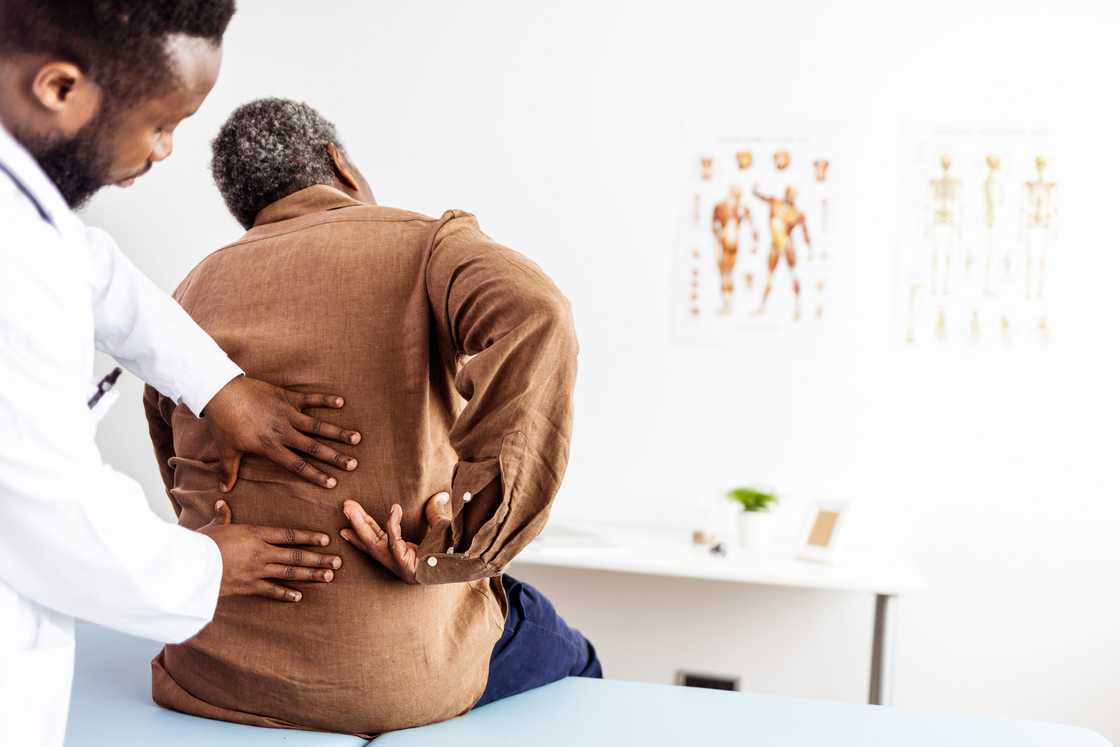 A caregiver checking the back of an elderly person