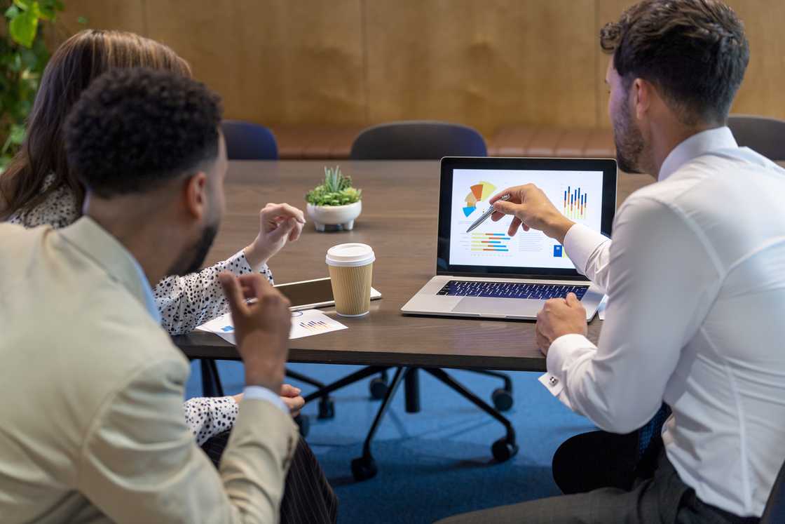 Co-workers discussing at an office desk