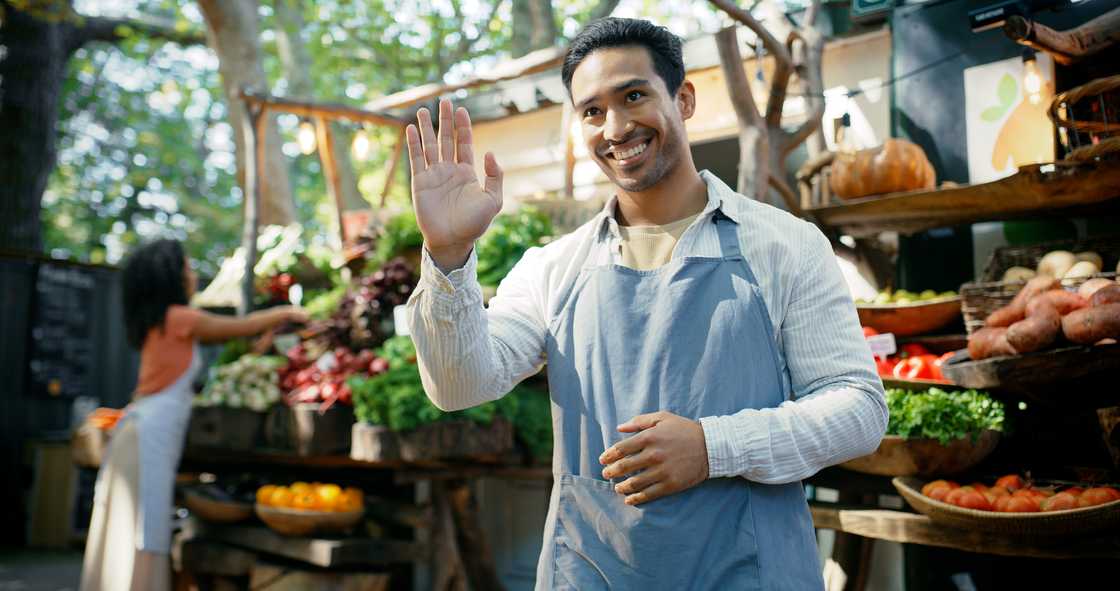 A grocery worker smiles after serving a client