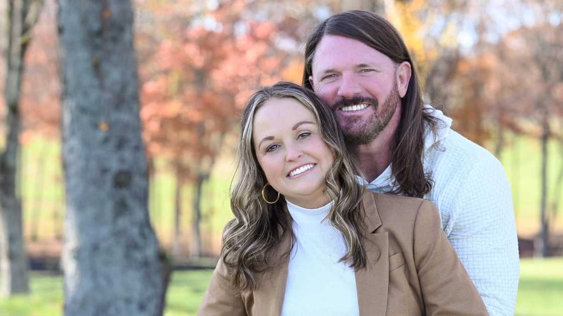 AJ Styles (L) poses with his wife Wendy (R) in a garden.