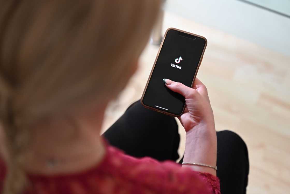 A lady accessing TikTok on a smartphone